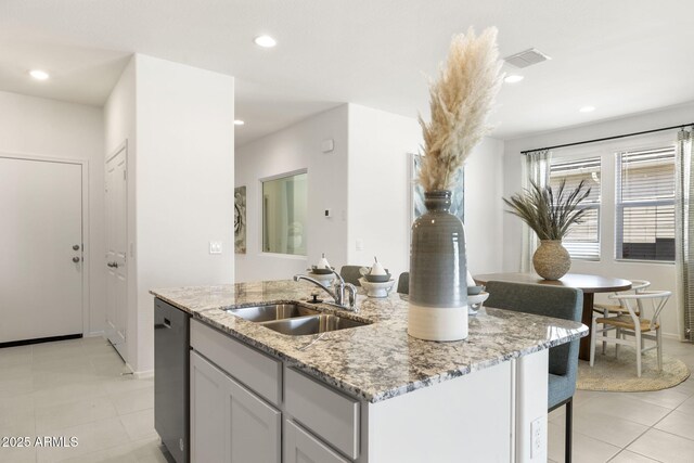 25461 W Graham Trl, Buckeye, AZ 85326 - kitchen featuring light stone counters, recessed lighting, a kitchen island with sink, stainless steel dishwasher, and a sink