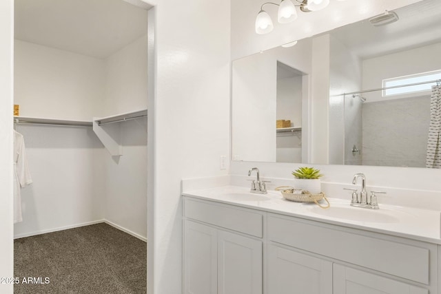 25461 W Graham Trl, Buckeye, AZ 85326 - full bathroom featuring a walk in closet, double vanity, and a sink