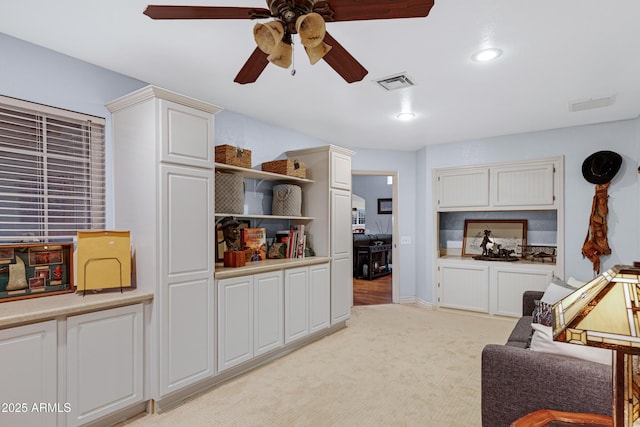 living room featuring light colored carpet, ceiling fan, visible vents, and recessed lighting