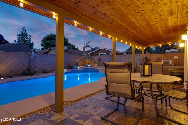 view of pool featuring a fenced backyard, a patio area, a fenced in pool, and outdoor dining space