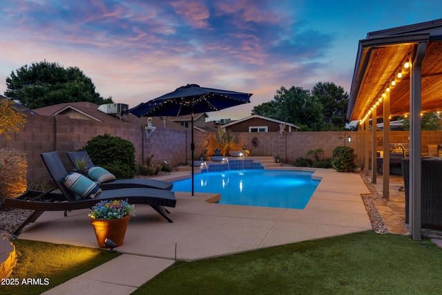 pool at dusk featuring a patio area, a fenced backyard, and a fenced in pool