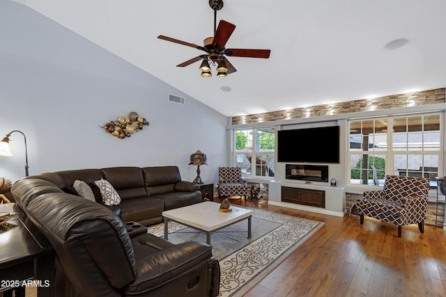 living room with hardwood / wood-style floors, visible vents, ceiling fan, and a healthy amount of sunlight