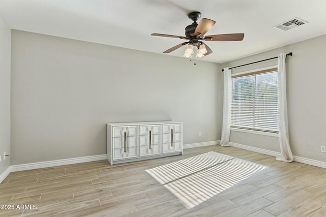 unfurnished room with light hardwood / wood-style flooring and ceiling fan