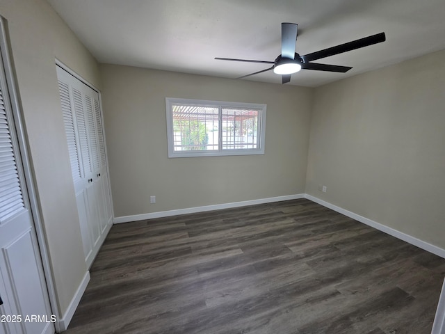 3849 W Mauna Loa Ln, Phoenix, AZ 85053 - unfurnished bedroom with dark wood finished floors, baseboards, a ceiling fan, and a closet