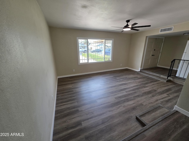 3849 W Mauna Loa Ln, Phoenix, AZ 85053 - empty room featuring baseboards, dark wood-type flooring, and ceiling fan