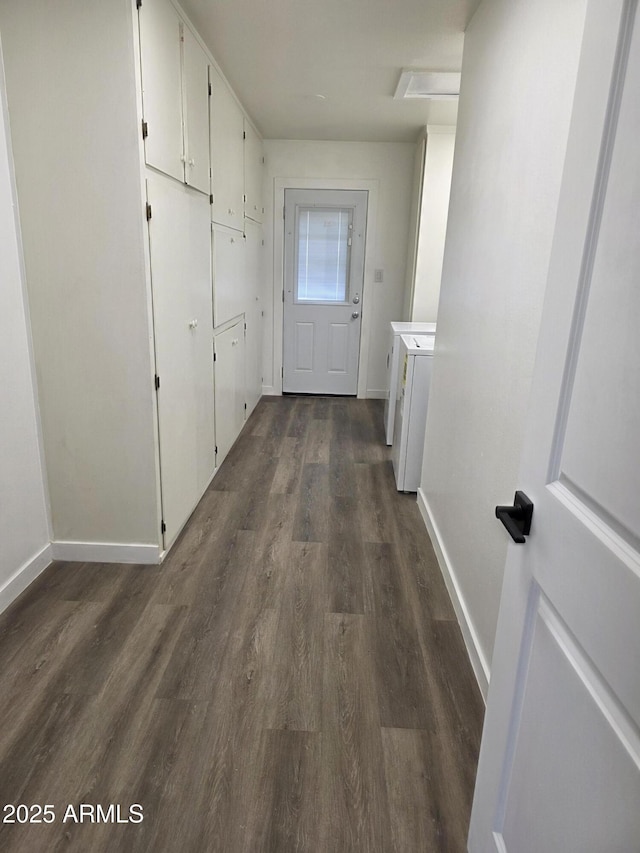 3849 W Mauna Loa Ln, Phoenix, AZ 85053 - corridor with dark wood-type flooring, baseboards, and washer and clothes dryer