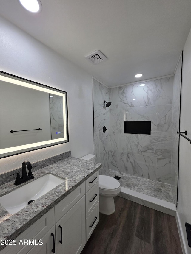 3849 W Mauna Loa Ln, Phoenix, AZ 85053 - full bath with vanity, a marble finish shower, toilet, wood finished floors, and recessed lighting