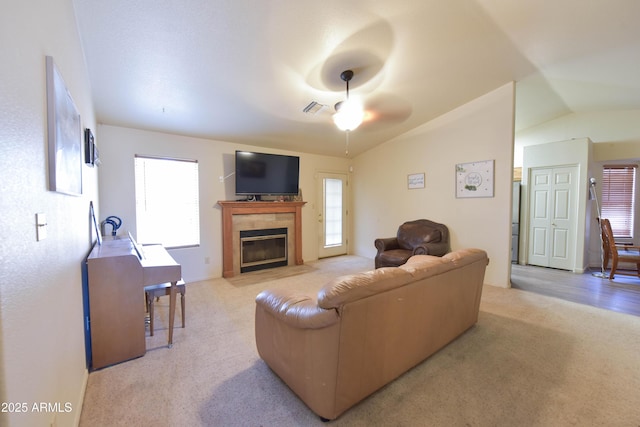 1219 E Avenida Isabela, Casa Grande, AZ 85122 - living area with a ceiling fan, light colored carpet, lofted ceiling, and a tiled fireplace