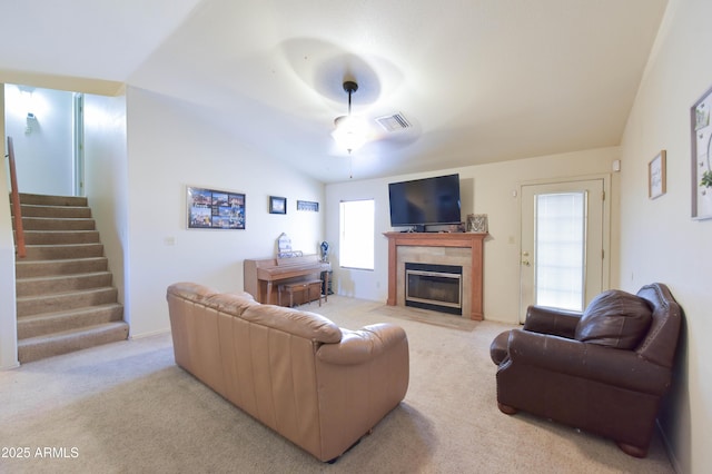 1219 E Avenida Isabela, Casa Grande, AZ 85122 - living room with light colored carpet, a tiled fireplace, stairway, and vaulted ceiling