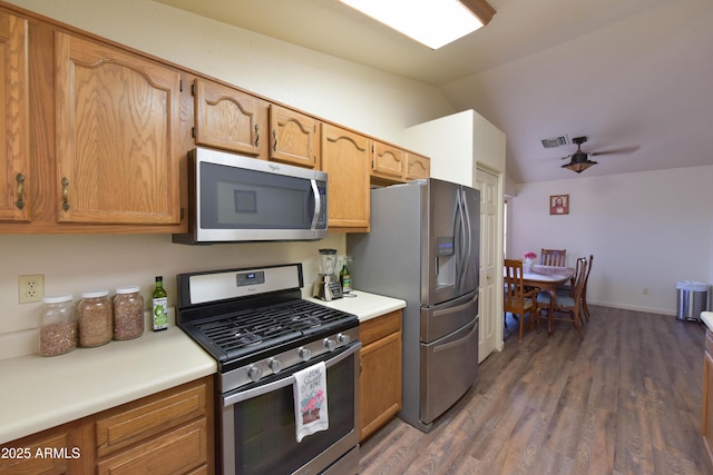 1219 E Avenida Isabela, Casa Grande, AZ 85122 - kitchen with stainless steel appliances, vaulted ceiling, wood finished floors, light countertops, and baseboards