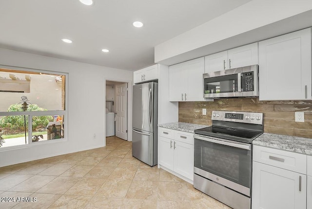 kitchen with decorative backsplash, light stone counters, white cabinetry, and stainless steel appliances