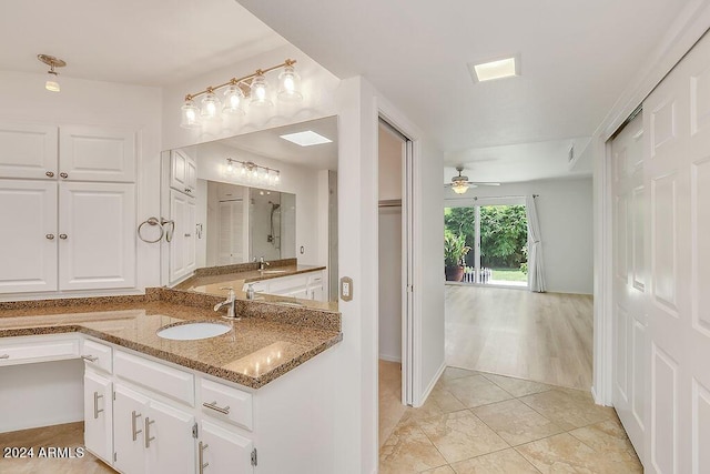 bathroom with vanity, ceiling fan, a shower, and wood-type flooring