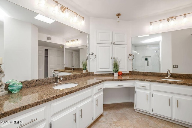 bathroom featuring vanity and a shower with door