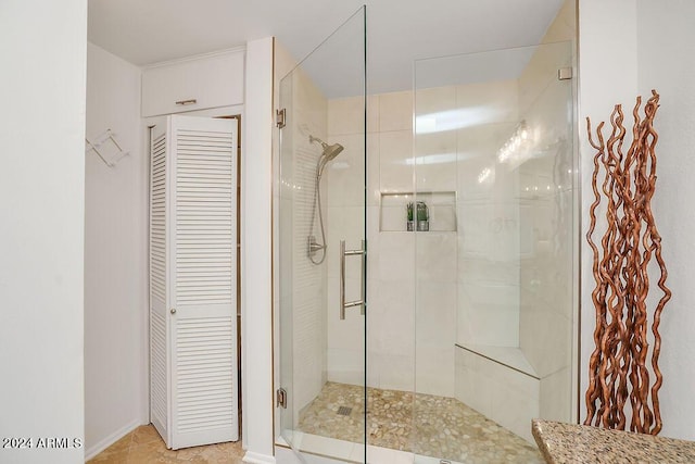 bathroom featuring tile patterned floors and a shower with shower door