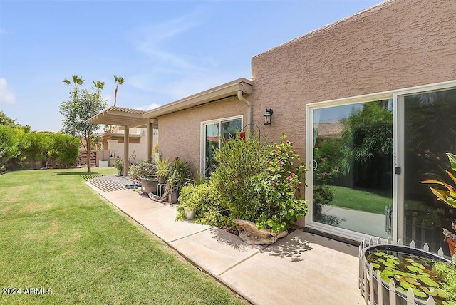 exterior space featuring a lawn and a patio area