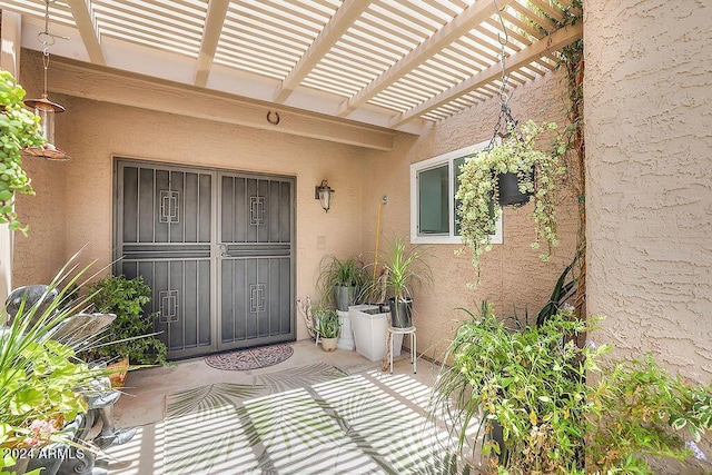 property entrance with a pergola