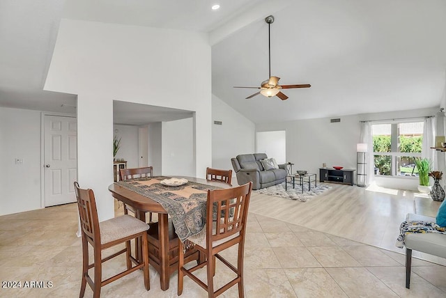 dining room featuring beamed ceiling, ceiling fan, light wood-type flooring, and high vaulted ceiling