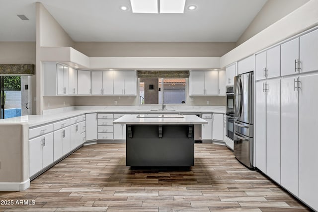 5345 E Mclellan Rd Unit 123, Mesa, AZ 85205 - kitchen featuring stainless steel appliances, light countertops, light wood-style flooring, white cabinets, and recessed lighting