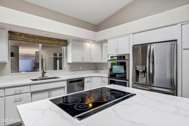 5345 E Mclellan Rd Unit 123, Mesa, AZ 85205 - kitchen with appliances with stainless steel finishes, a sink, lofted ceiling, white cabinetry, and light stone countertops
