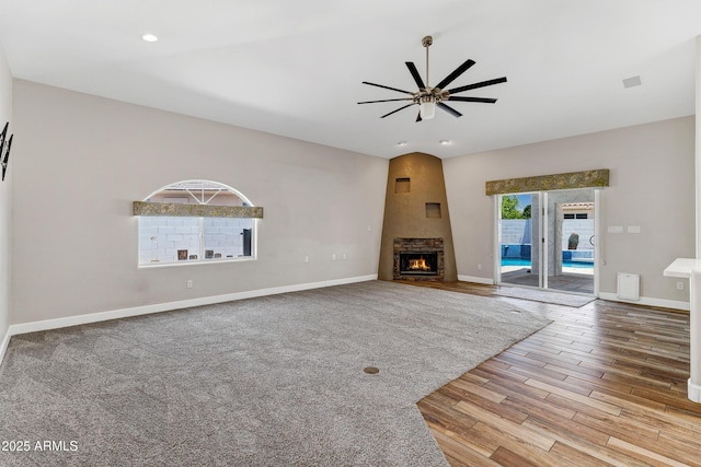 5345 E Mclellan Rd Unit 123, Mesa, AZ 85205 - unfurnished living room featuring a ceiling fan, a lit fireplace, wood finished floors, baseboards, and recessed lighting