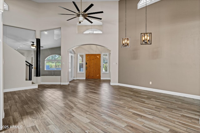 5345 E Mclellan Rd Unit 123, Mesa, AZ 85205 - entryway featuring ceiling fan, a chandelier, a high ceiling, wood finished floors, and arched walkways