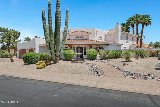 5345 E Mclellan Rd Unit 123, Mesa, AZ 85205 - view of front of home with stucco siding, a tiled roof, an attached garage, a chimney, and driveway