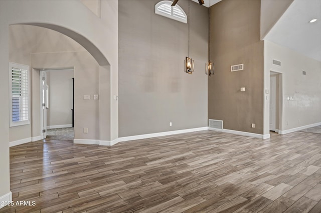 5345 E Mclellan Rd Unit 123, Mesa, AZ 85205 - entrance foyer with wood finished floors, a high ceiling, baseboards, and arched walkways