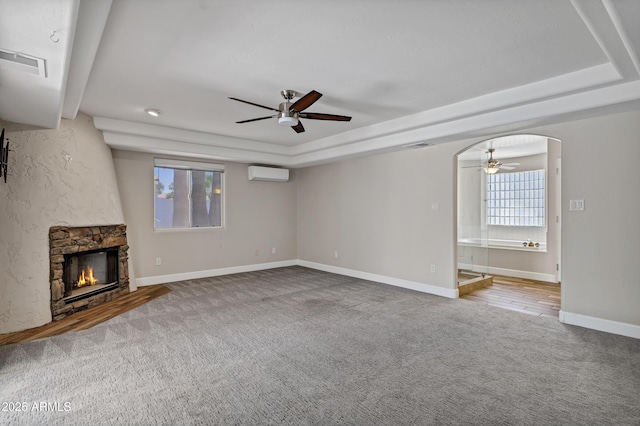5345 E Mclellan Rd Unit 123, Mesa, AZ 85205 - unfurnished living room featuring ceiling fan, a raised ceiling, carpet, and a wall unit AC
