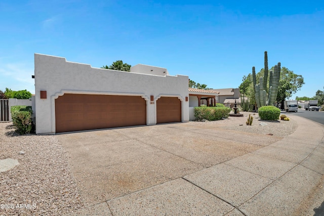 5345 E Mclellan Rd Unit 123, Mesa, AZ 85205 - pueblo revival-style home with stucco siding, an attached garage, and concrete driveway