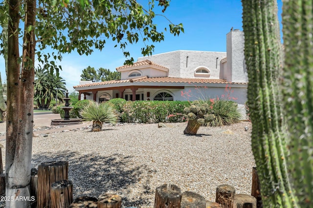 5345 E Mclellan Rd Unit 123, Mesa, AZ 85205 - rear view of house with stucco siding, a tile roof, and a chimney