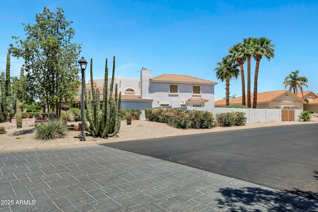 5345 E Mclellan Rd Unit 123, Mesa, AZ 85205 - mediterranean / spanish-style house featuring stucco siding, a tiled roof, and a chimney