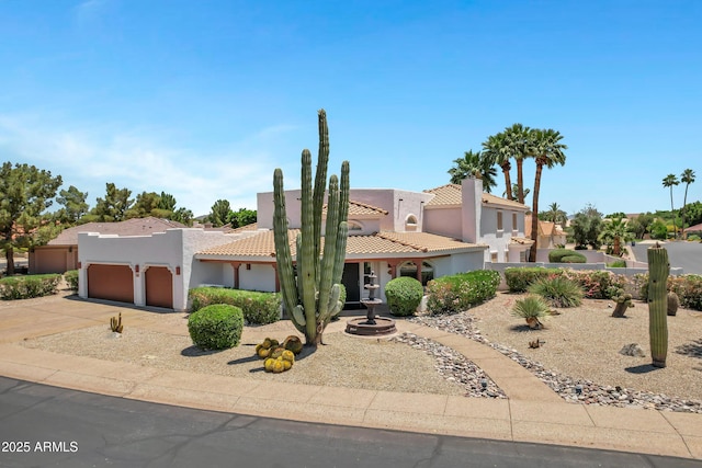5345 E Mclellan Rd Unit 123, Mesa, AZ 85205 - view of front of home featuring an attached garage, concrete driveway, stucco siding, and a tiled roof