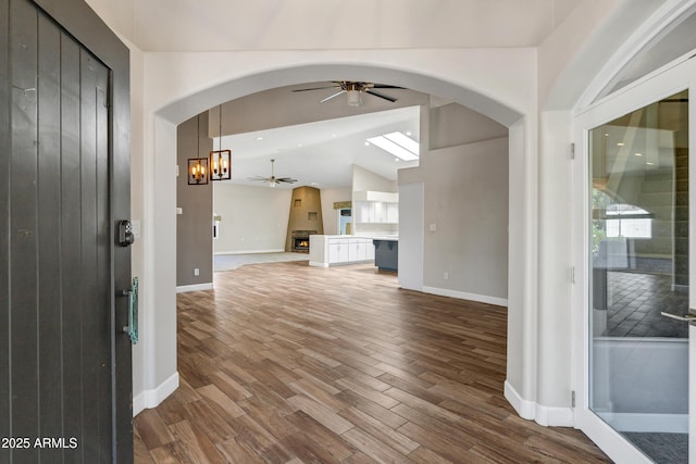 5345 E Mclellan Rd Unit 123, Mesa, AZ 85205 - entrance foyer featuring a ceiling fan, wood finished floors, arched walkways, lofted ceiling, and baseboards