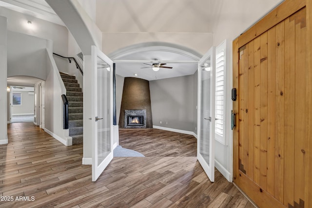 5345 E Mclellan Rd Unit 123, Mesa, AZ 85205 - foyer entrance with ceiling fan, a glass covered fireplace, wood finished floors, and stairway