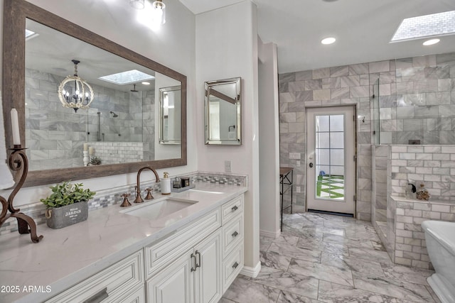 bathroom with tile walls, a skylight, and separate shower and tub