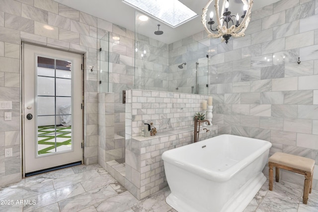 bathroom with a skylight, separate shower and tub, and tile walls