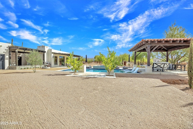 view of swimming pool with a gazebo and a patio area