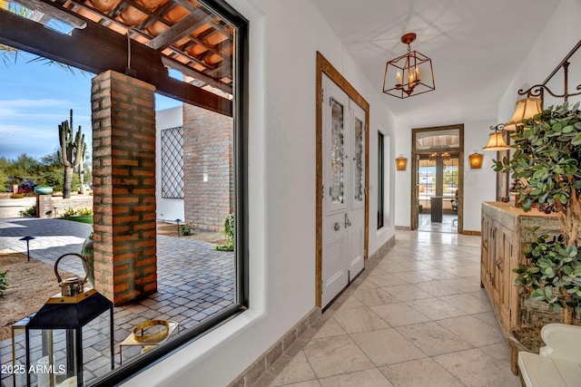 doorway to outside with french doors and an inviting chandelier