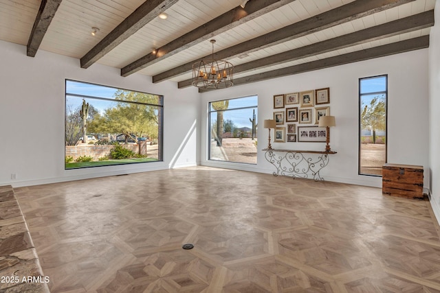 unfurnished living room with parquet floors, beam ceiling, wooden ceiling, and a chandelier