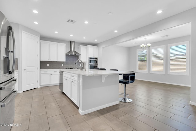 550 E Zion Pl, Chandler, AZ 85249 - kitchen with wall chimney range hood, appliances with stainless steel finishes, decorative backsplash, recessed lighting, and a kitchen breakfast bar