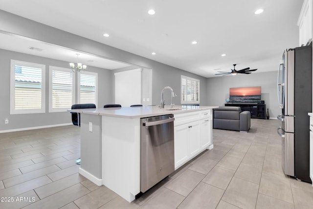 550 E Zion Pl, Chandler, AZ 85249 - kitchen featuring stainless steel appliances, open floor plan, ceiling fan, light countertops, and white cabinetry