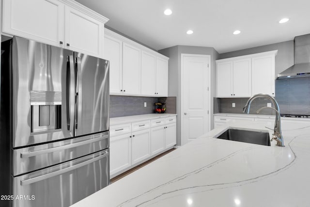 550 E Zion Pl, Chandler, AZ 85249 - kitchen with stainless steel fridge, wall chimney exhaust hood, recessed lighting, white cabinets, and decorative backsplash