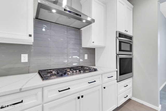 550 E Zion Pl, Chandler, AZ 85249 - kitchen featuring range hood, appliances with stainless steel finishes, tasteful backsplash, and light stone counters