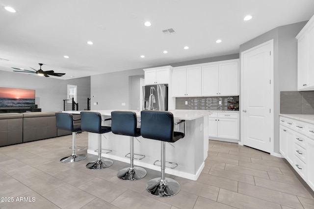 550 E Zion Pl, Chandler, AZ 85249 - kitchen featuring stainless steel fridge, open floor plan, decorative backsplash, recessed lighting, and a breakfast bar