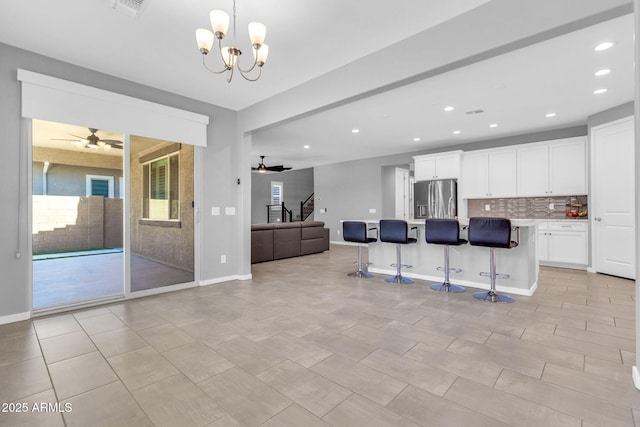 550 E Zion Pl, Chandler, AZ 85249 - kitchen with stainless steel fridge with ice dispenser, open floor plan, a ceiling fan, a kitchen breakfast bar, and recessed lighting