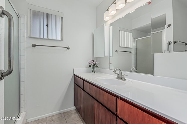 6051 E Ensenada St, Mesa, AZ 85205 - bathroom featuring a shower with door, vanity, baseboards, and tile patterned flooring