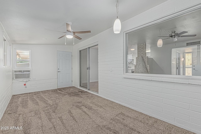 6051 E Ensenada St, Mesa, AZ 85205 - spare room with a ceiling fan, carpet, cooling unit, and brick wall