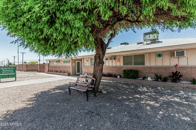6051 E Ensenada St, Mesa, AZ 85205 - ranch-style house featuring brick siding and board and batten siding
