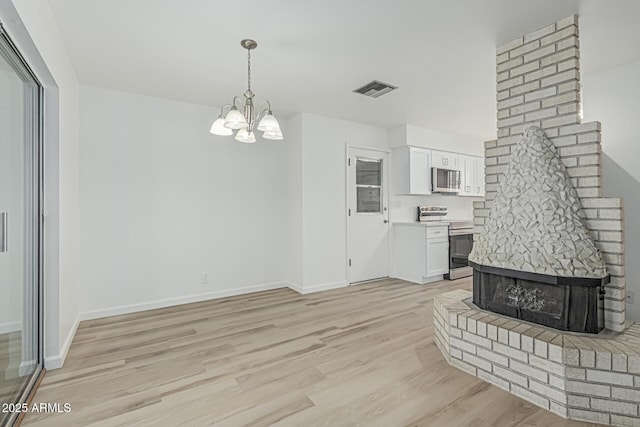 6051 E Ensenada St, Mesa, AZ 85205 - unfurnished living room with a chandelier, light wood-type flooring, and baseboards