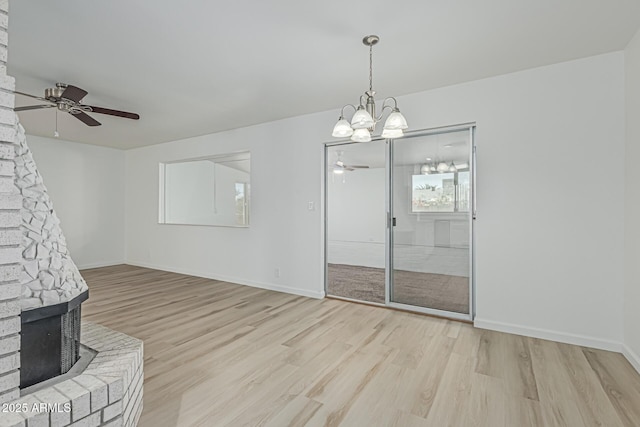 6051 E Ensenada St, Mesa, AZ 85205 - interior space featuring ceiling fan, light wood-style floors, and a fireplace